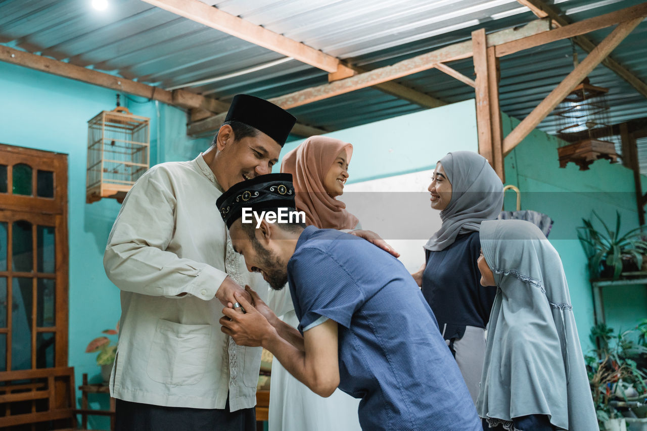 Family greeting each other during festival at home