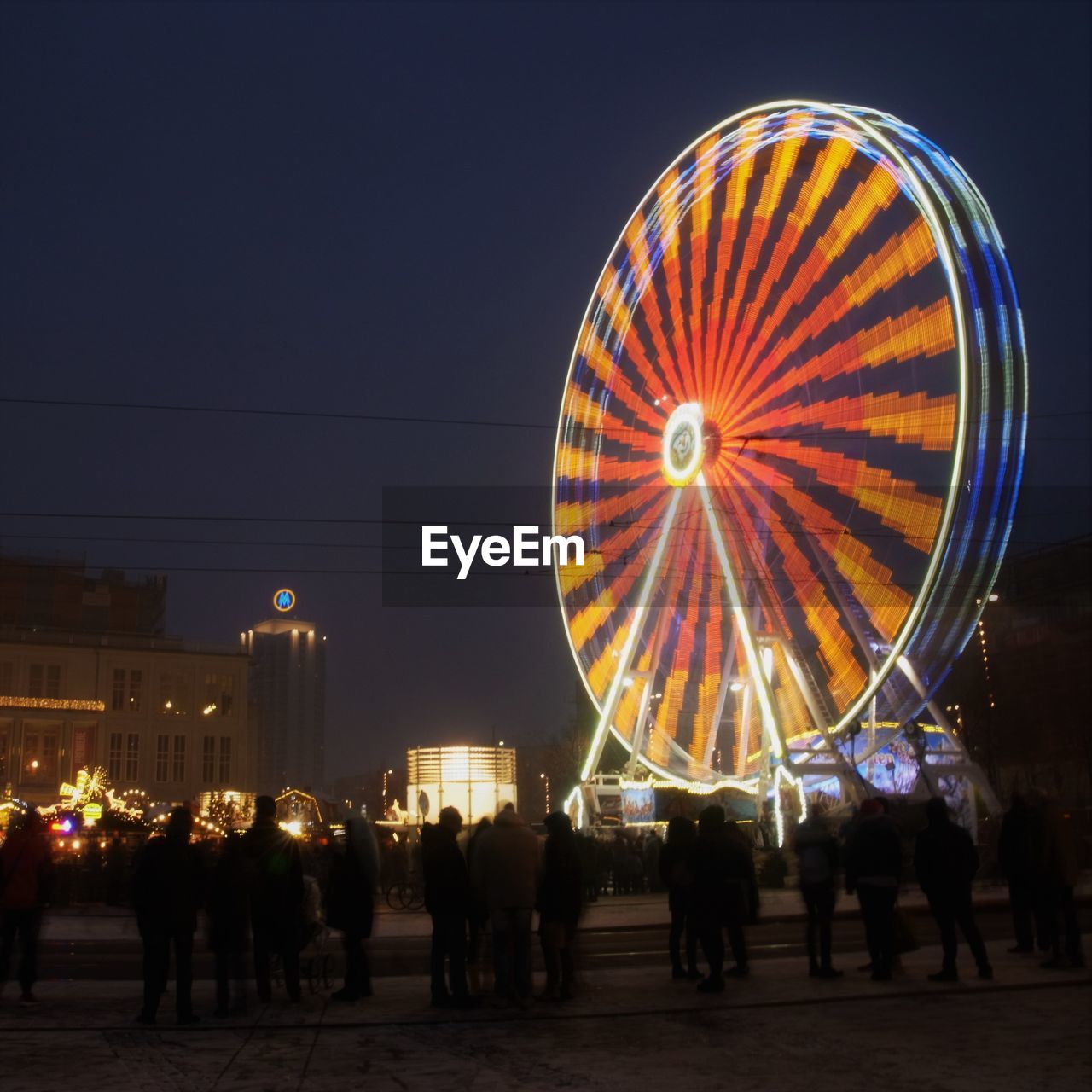 PEOPLE AT AMUSEMENT PARK AGAINST SKY