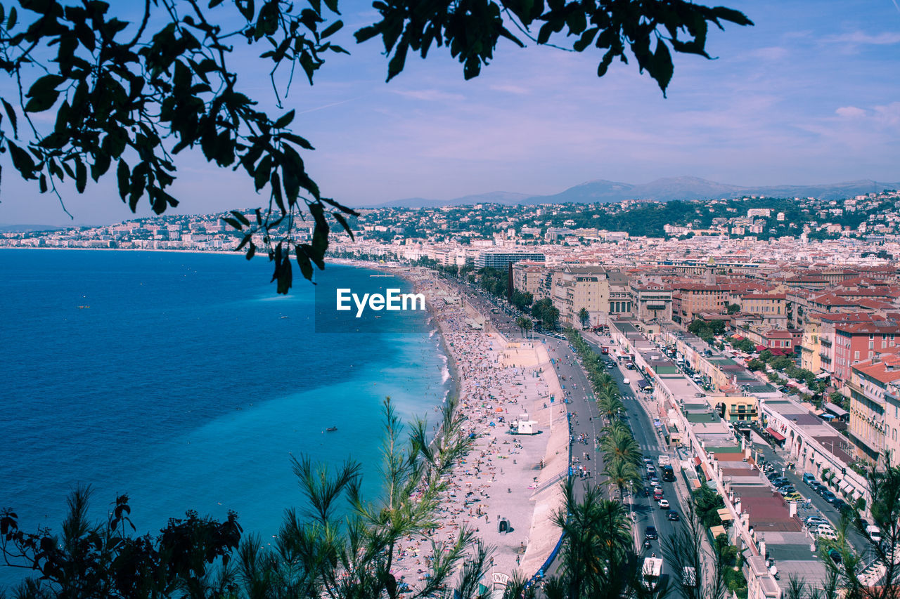 High angle view of townscape by sea against sky