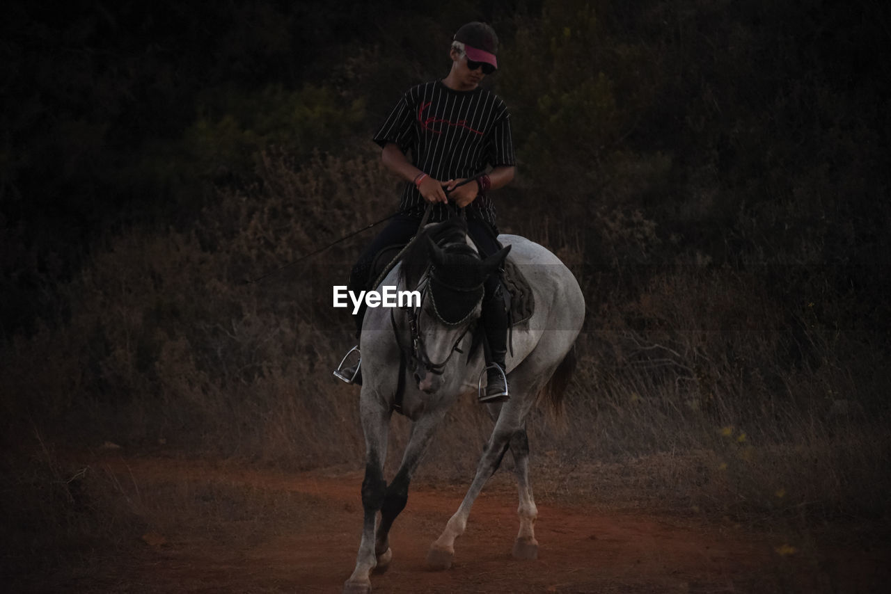 FULL LENGTH OF MAN RIDING HORSE