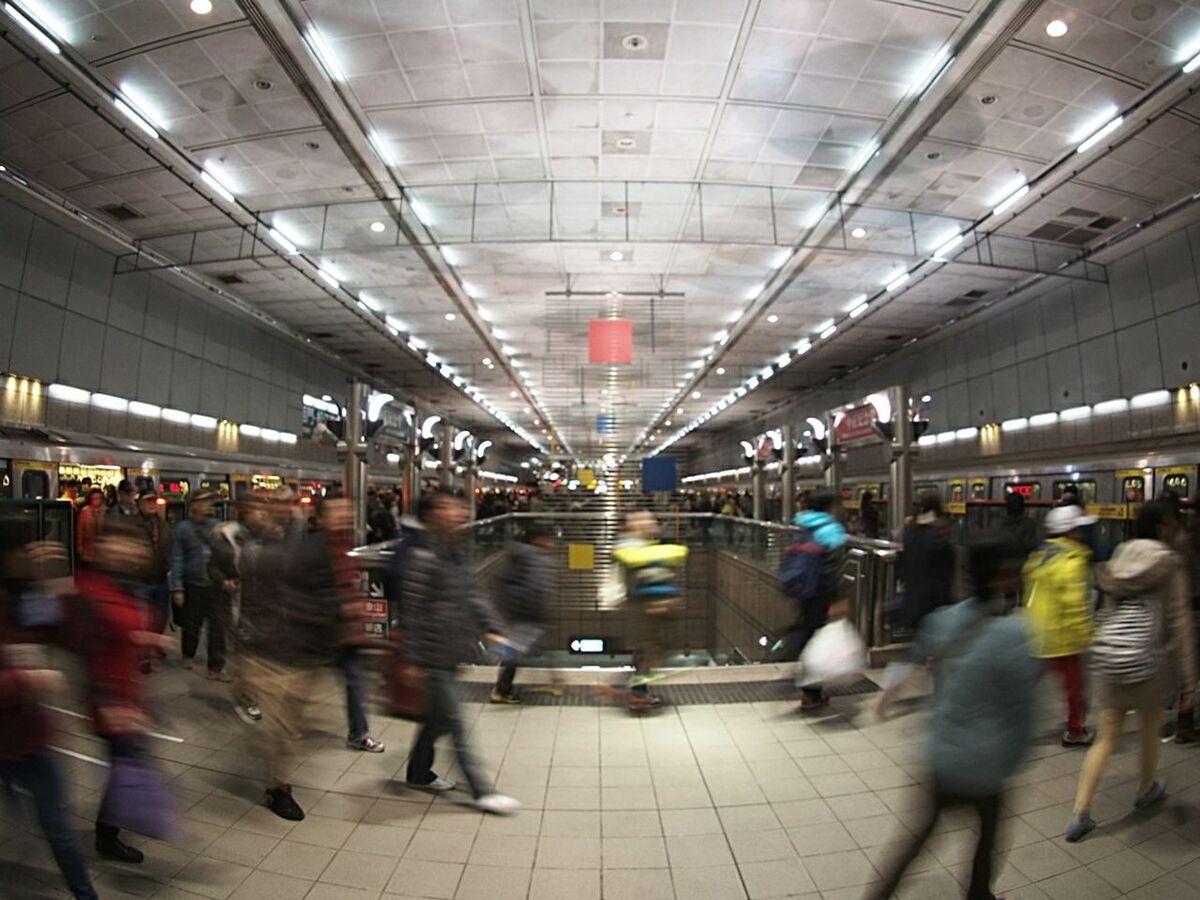 Blurred motion of people at illuminated railroad station