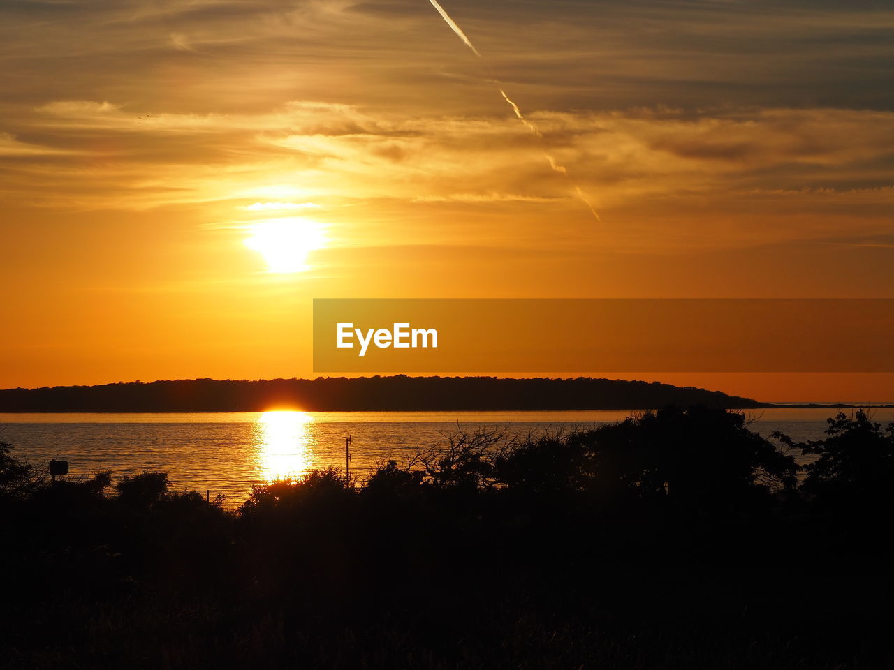 SCENIC VIEW OF LAKE AGAINST ORANGE SKY DURING SUNSET