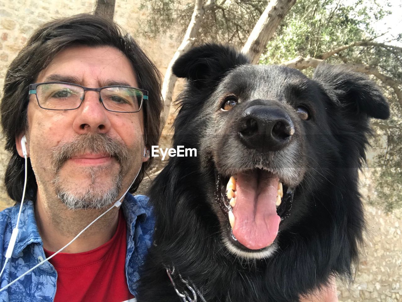 Portrait of man with dog outdoors