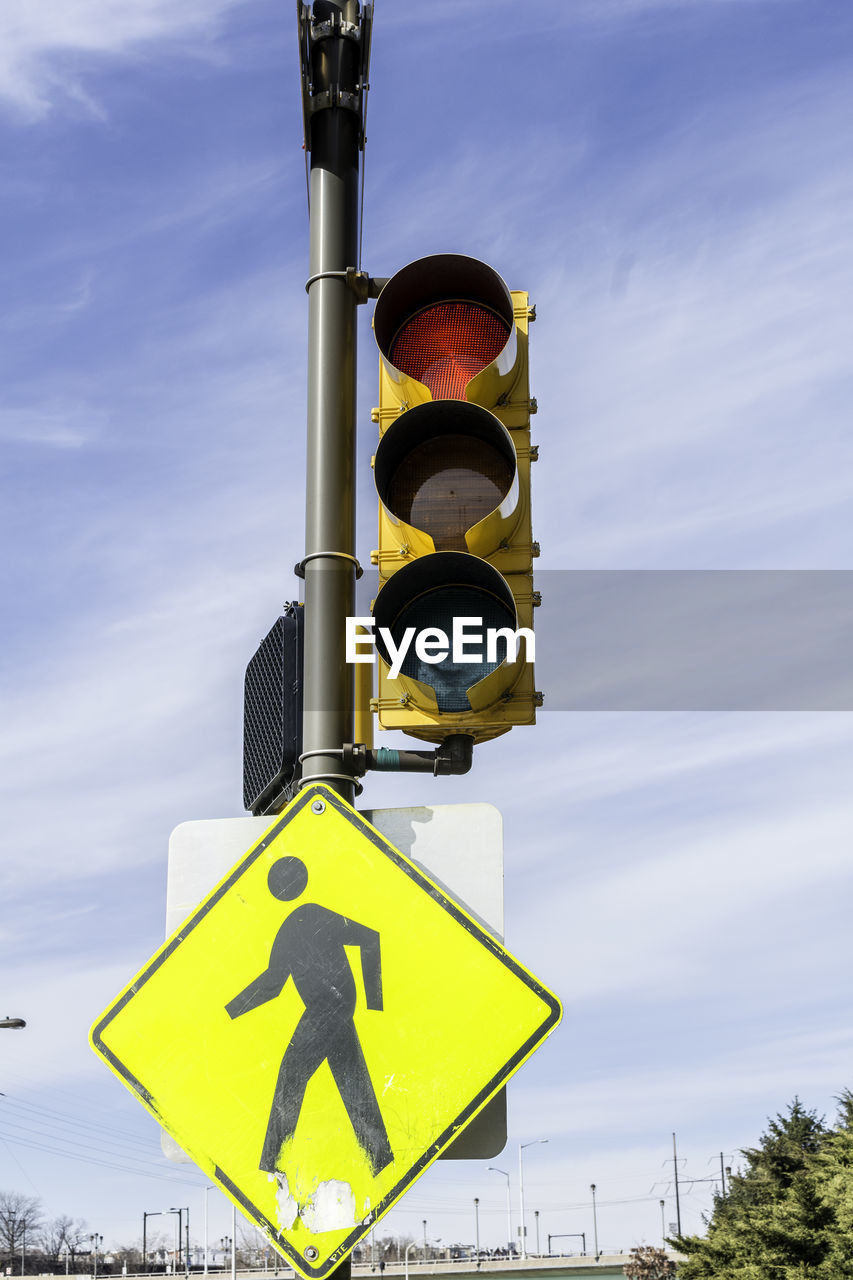 Low angle view of road sign against sky