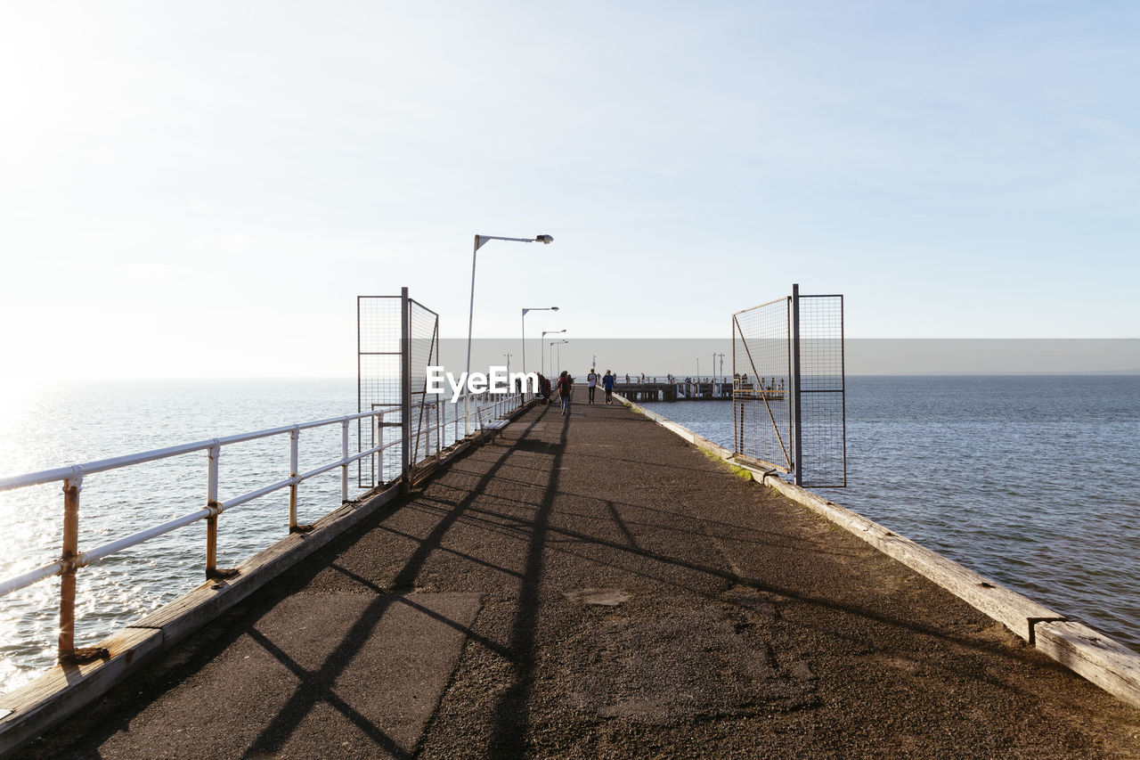 Pier over sea against clear sky