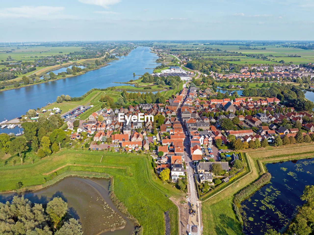 high angle view of townscape by sea against sky