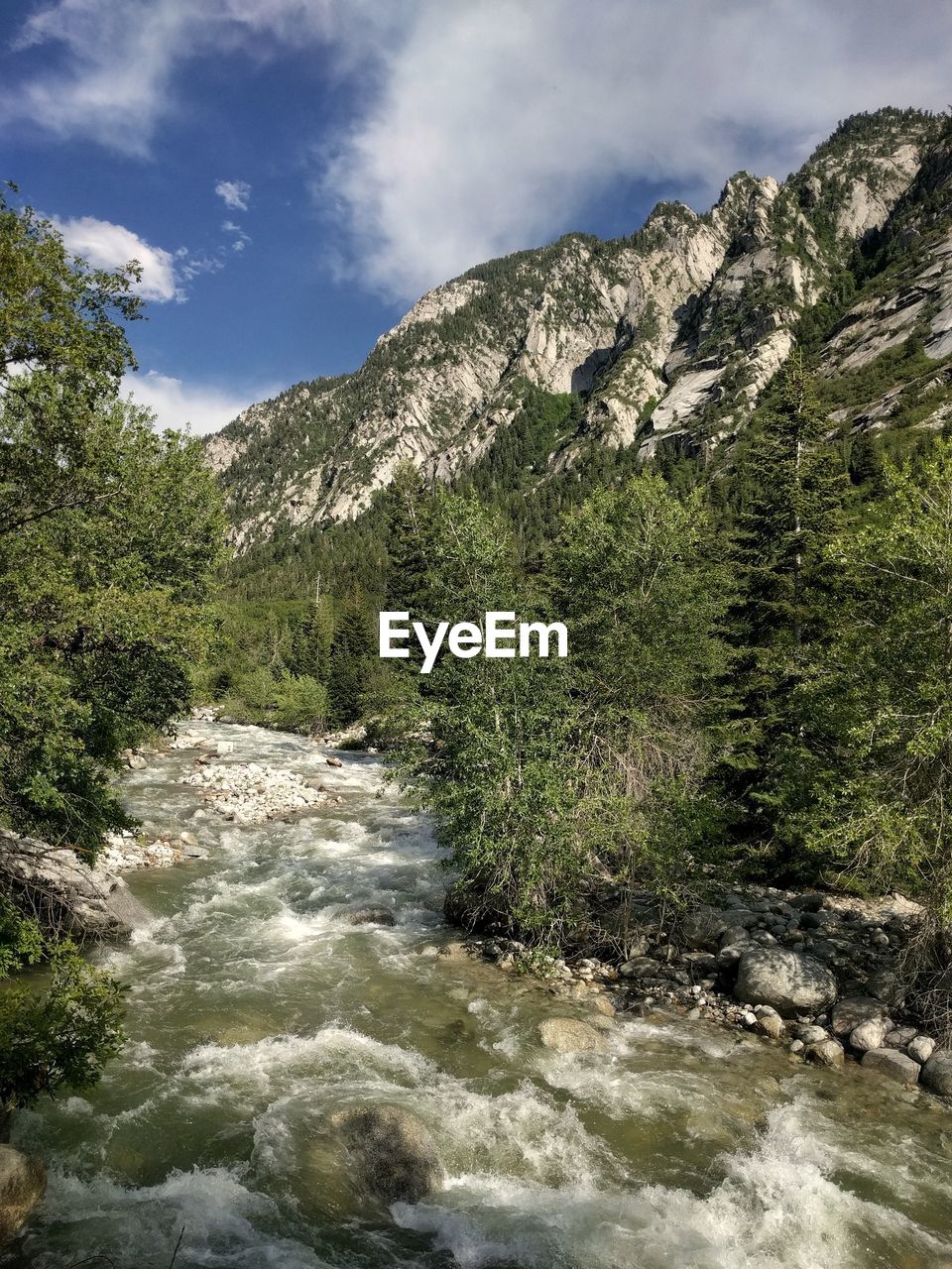 Scenic view of river amidst mountains against sky