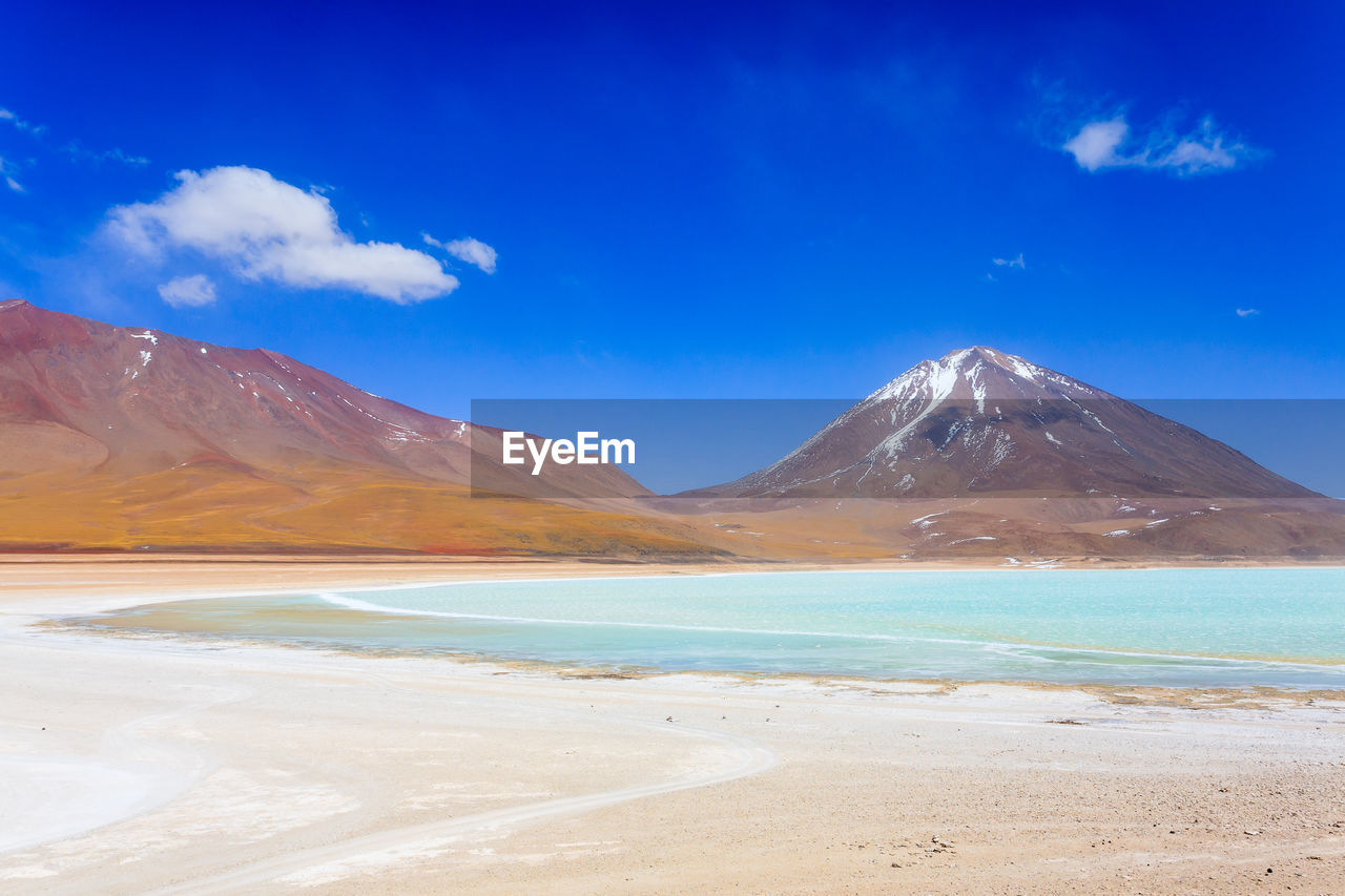 SCENIC VIEW OF SEA AGAINST MOUNTAINS