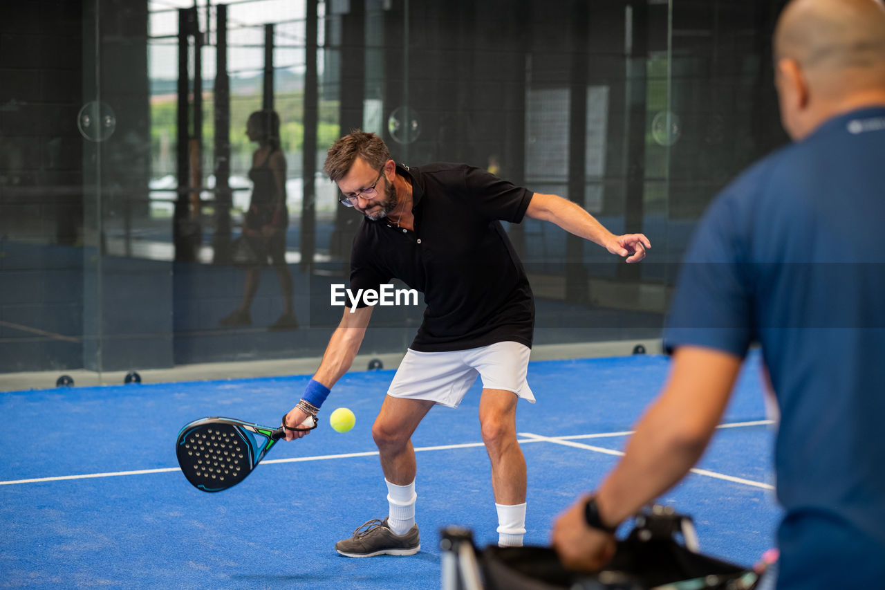 Man playing with ball in background