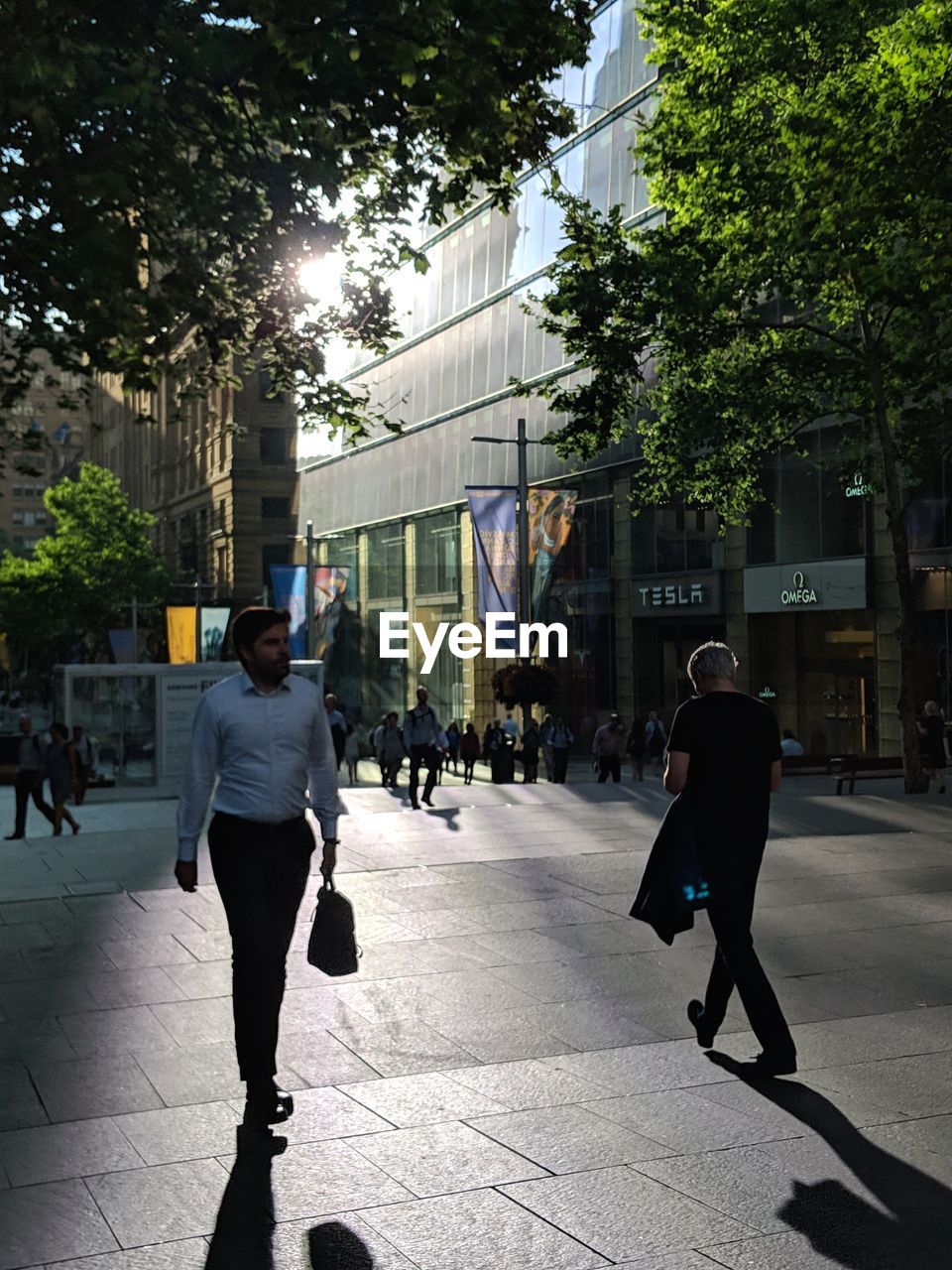 MAN WALKING ON STREET IN CITY