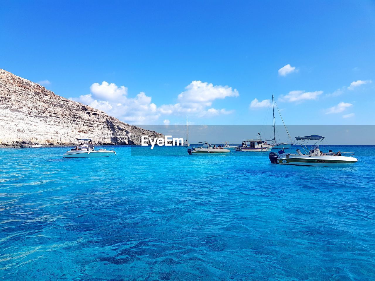 BOATS MOORED ON SEA