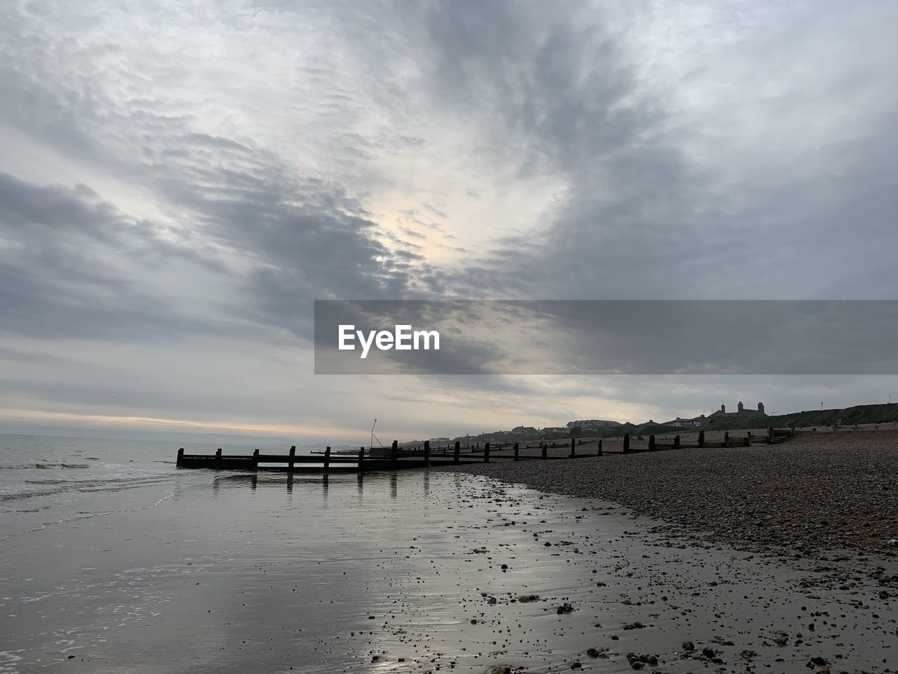 Scenic view of beach against sky during sunset