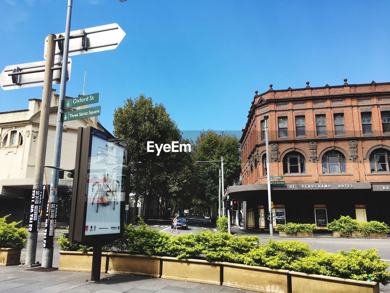 Street by building against clear blue sky