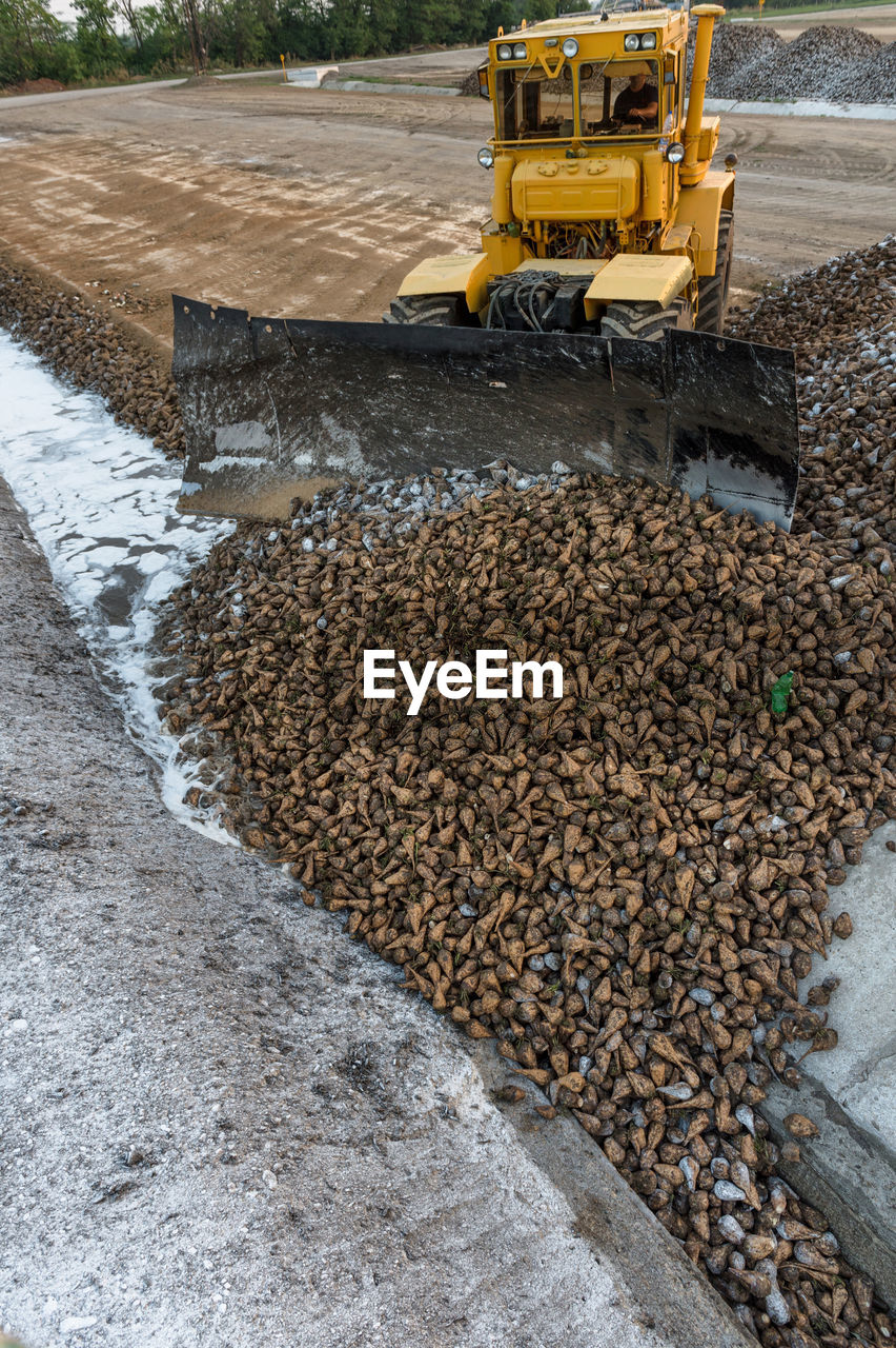 Earth mover at construction site against sky