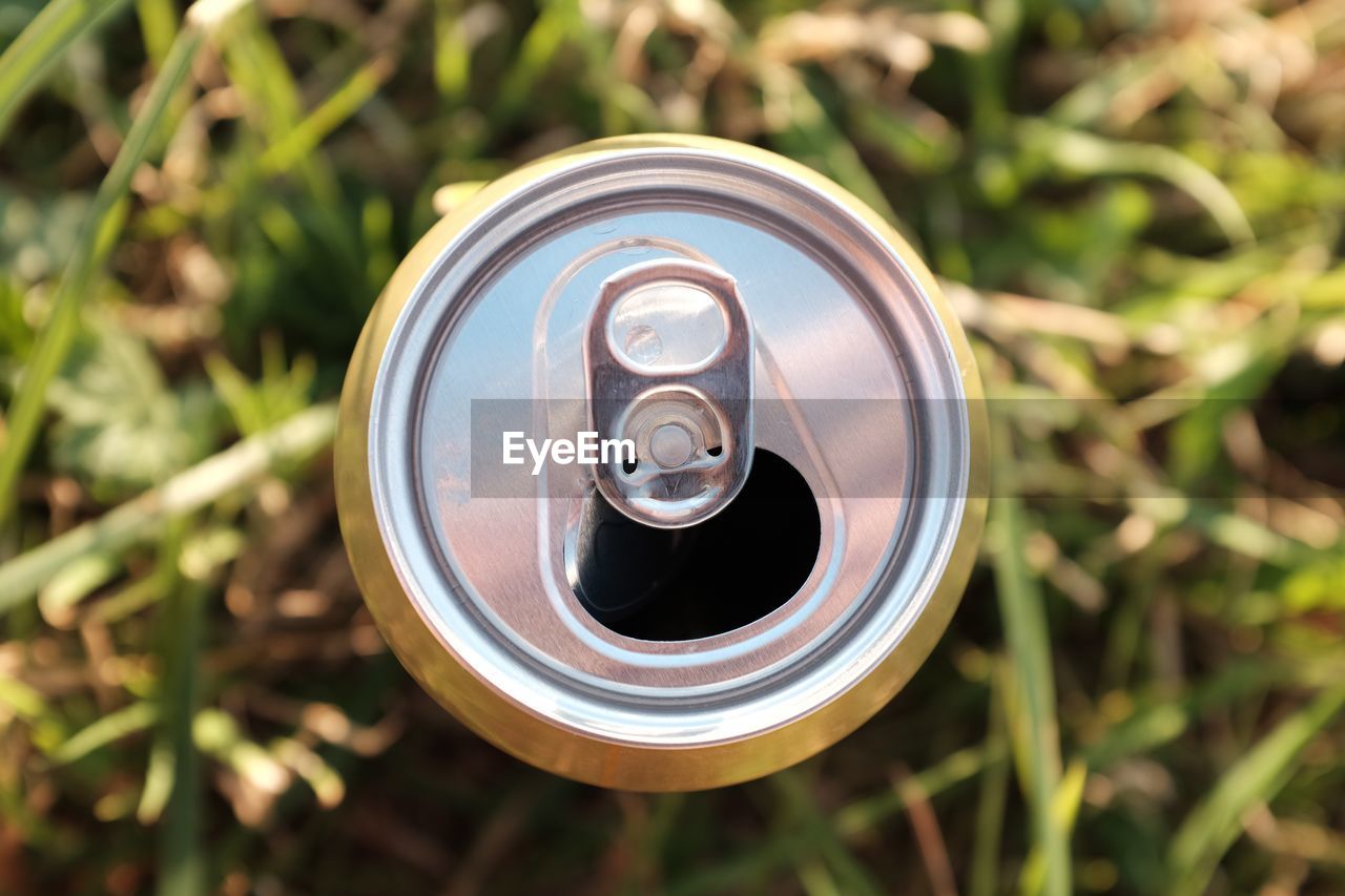 Directly above shot of open beer can on grass