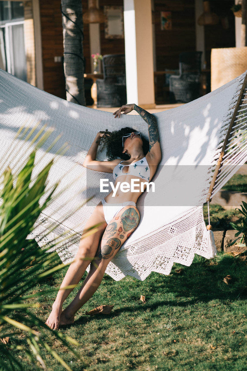 Young woman laying in a hammock 