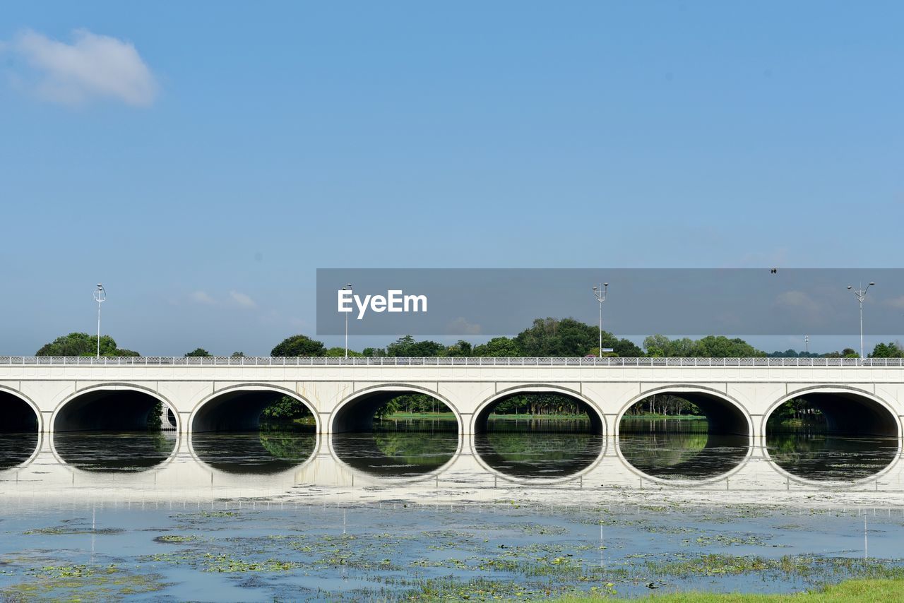 Image of a concrete bridge above a lake with reflection. beautiful bridge reflection