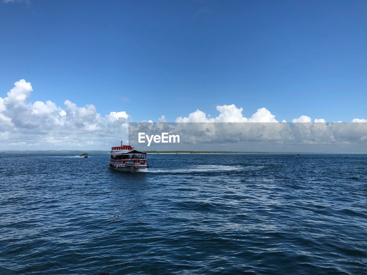 Boat sailing in sea against sky