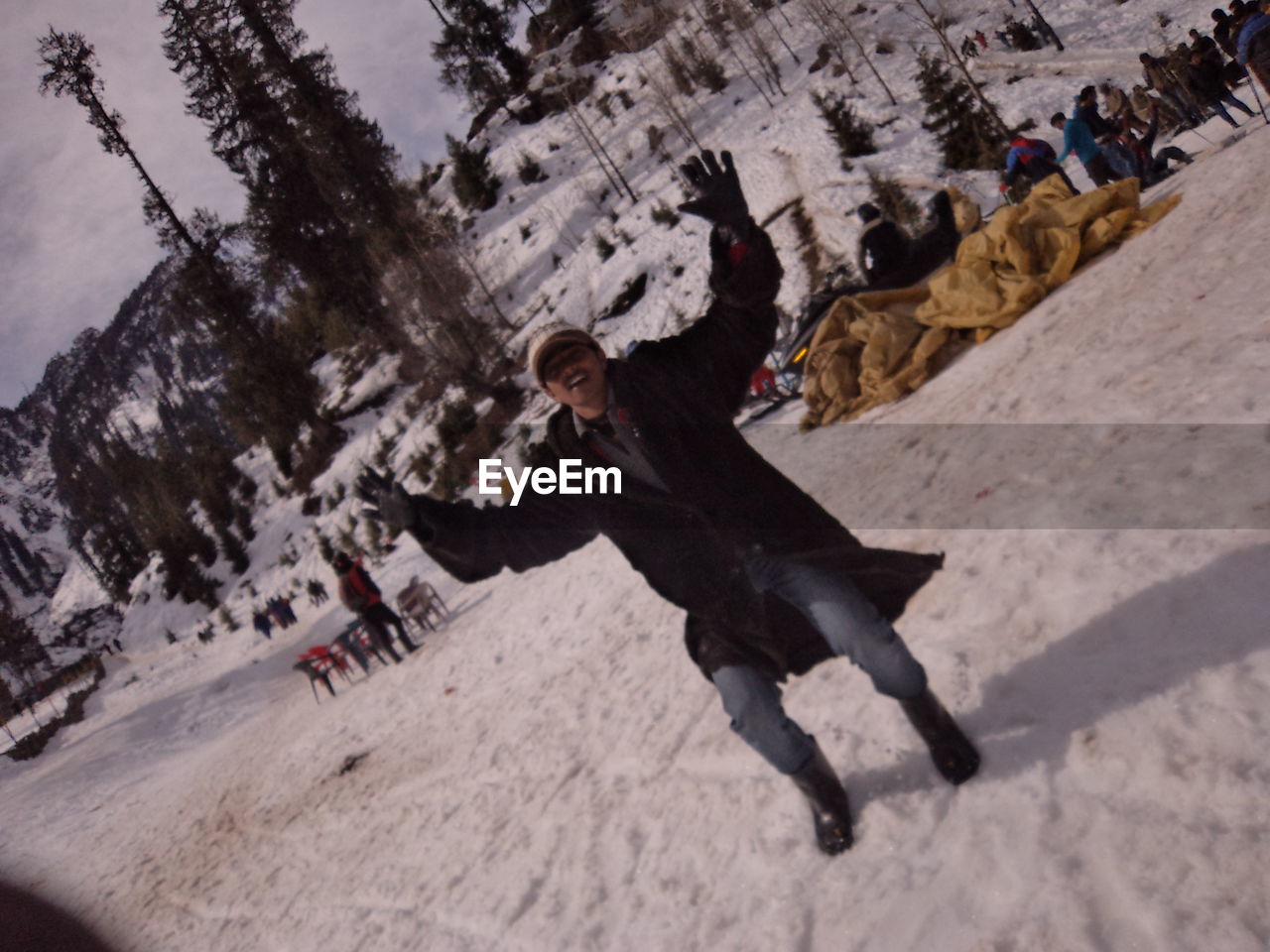 HIGH ANGLE VIEW OF MAN CLIMBING ON SNOW