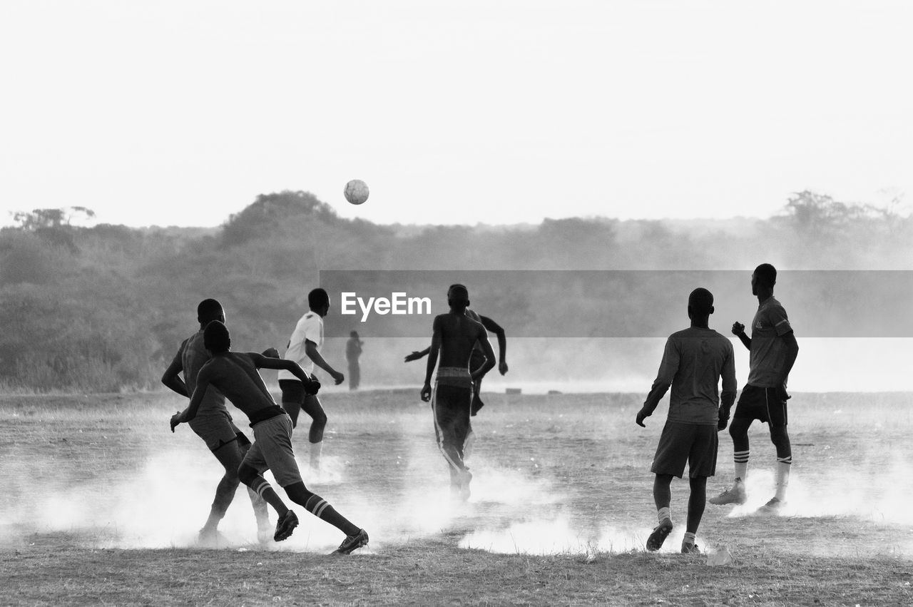 People playing soccer on field