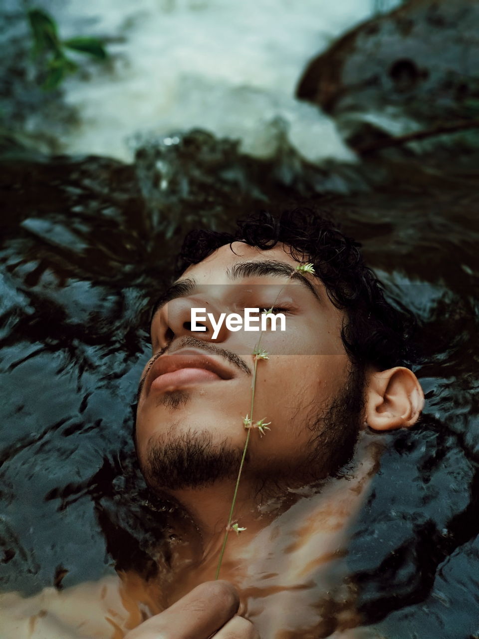 High angle view of young man swimming in river