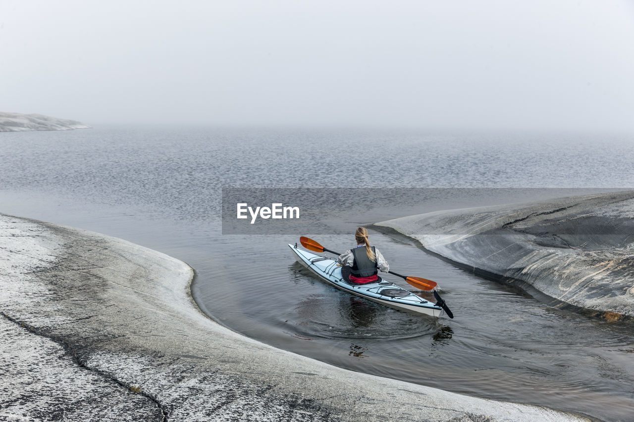 Woman canoeing, sweden