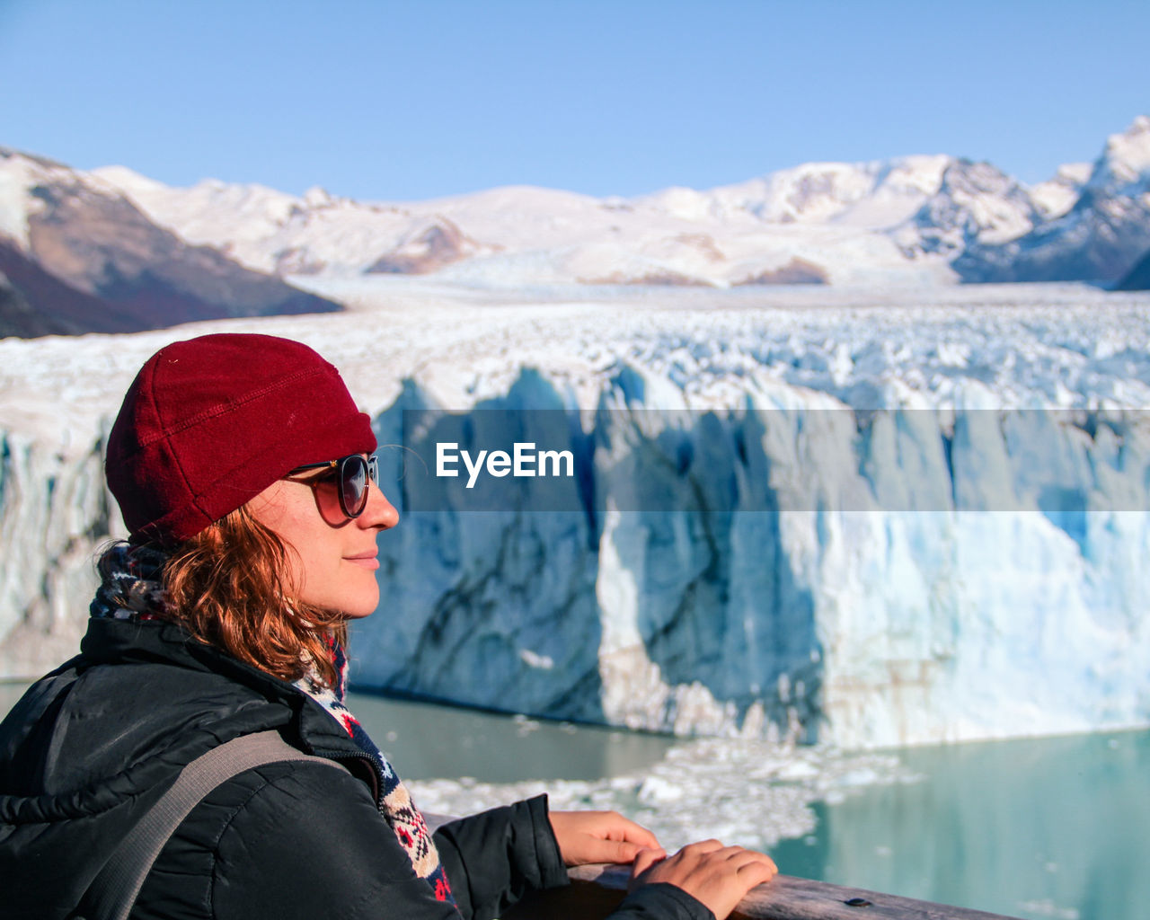 Woman standing on snowcapped mountains during winter in glacier perito moreno