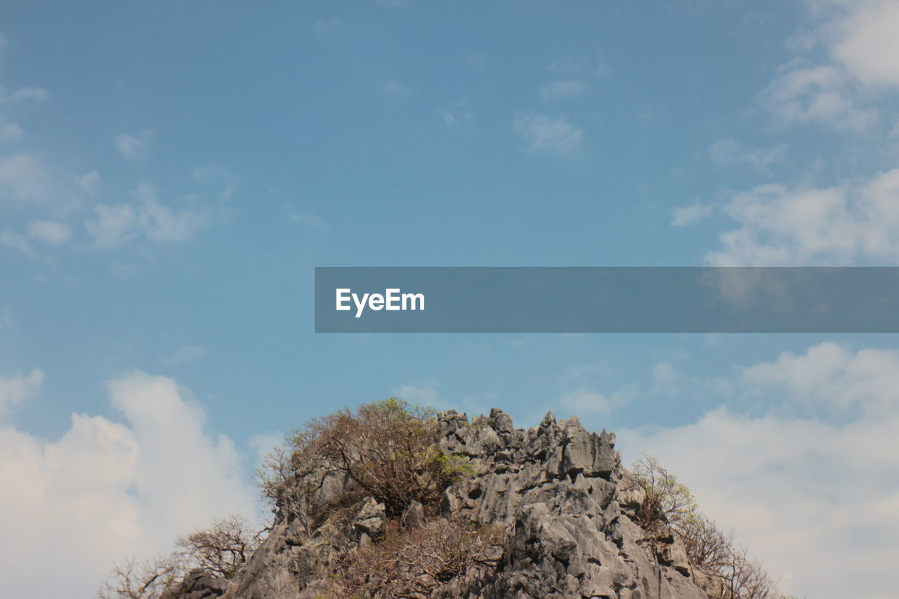 sky, cloud, nature, rock, low angle view, mountain, day, no people, tree, plant, outdoors, sunlight, beauty in nature, scenics - nature, blue, tranquility, copy space, sea