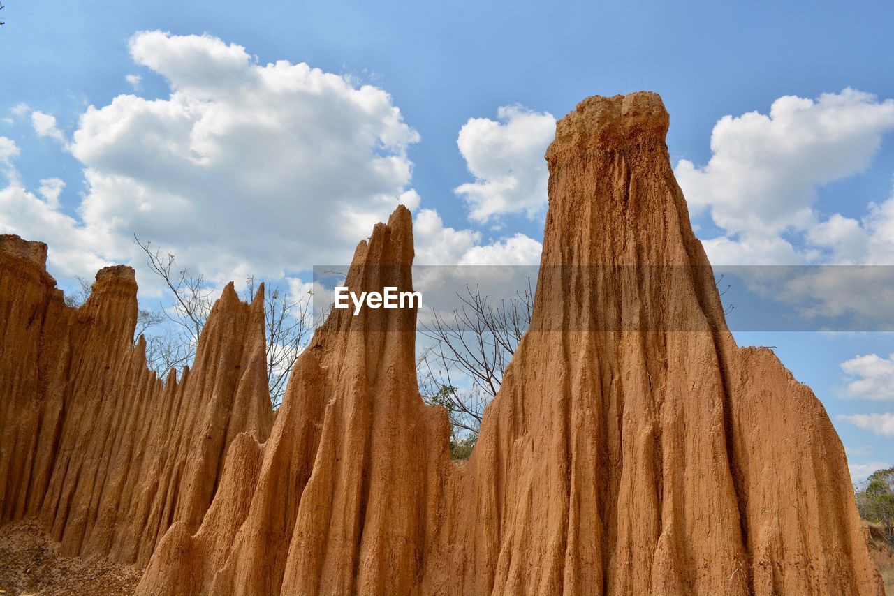 LOW ANGLE VIEW OF ROCK FORMATION AGAINST SKY