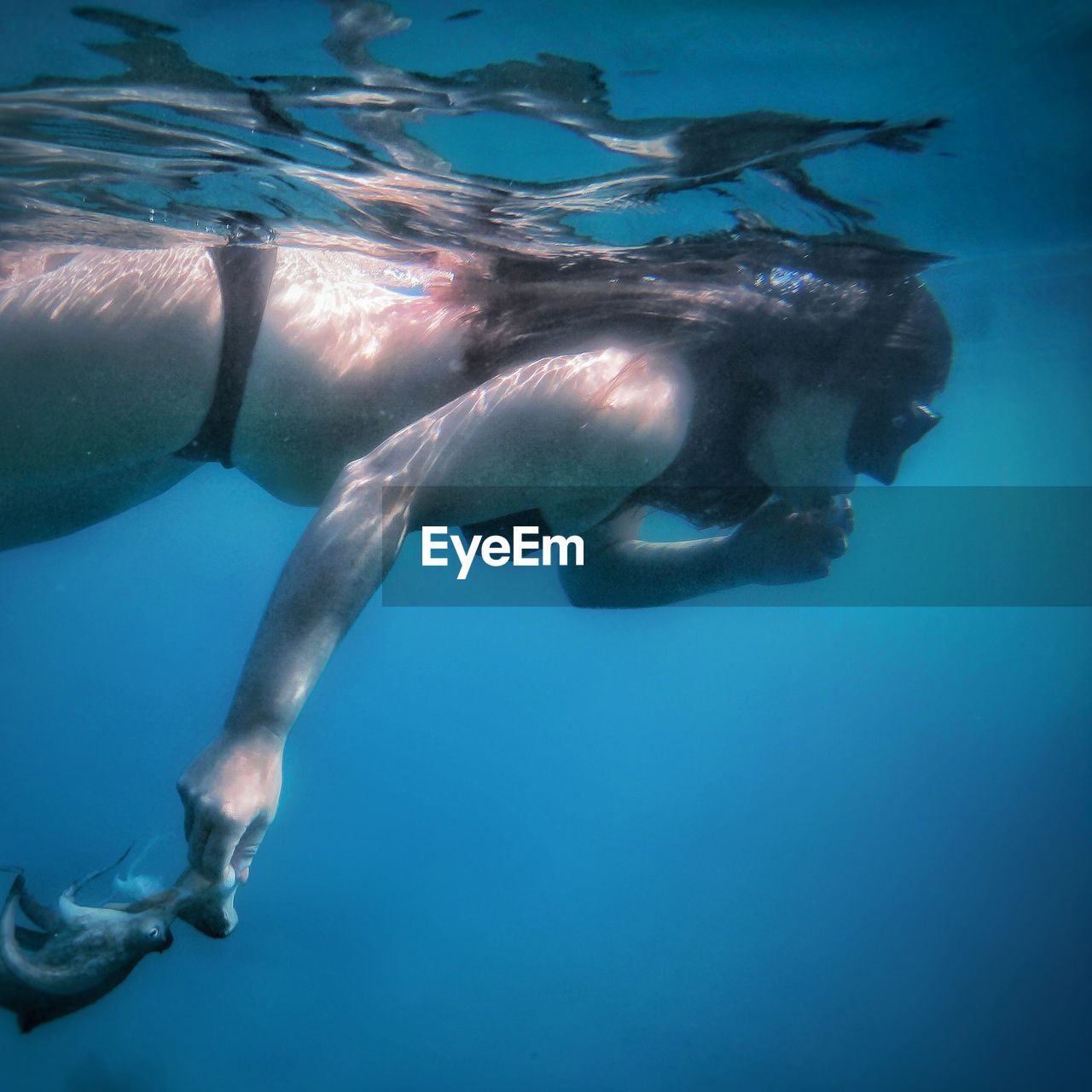 young woman swimming in sea