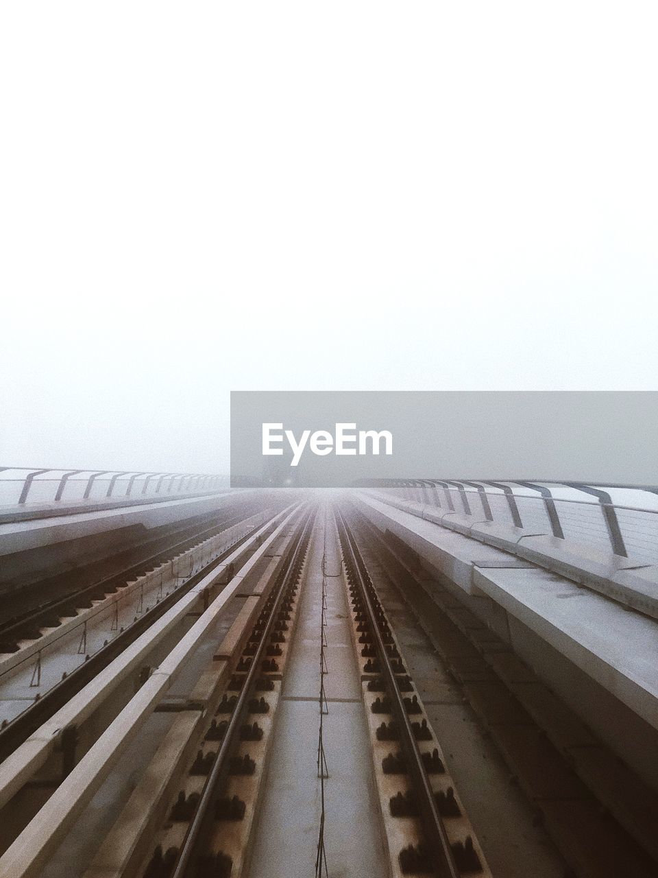 Railroad bridge against sky during foggy weather