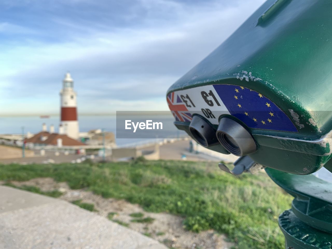 Binoculars and europa point lighthouse with european and british flags