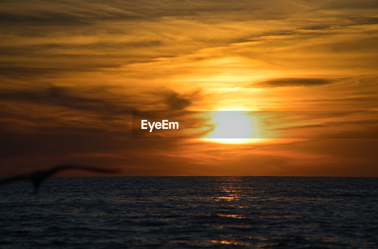 Scenic view of sea and waves against sky during sunset mystical and romantic