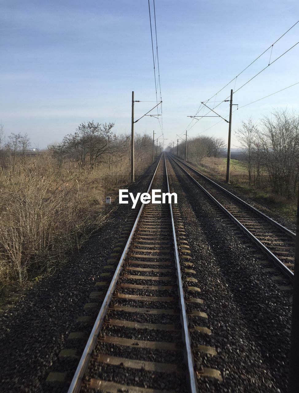 Railroad track against cloudy sky