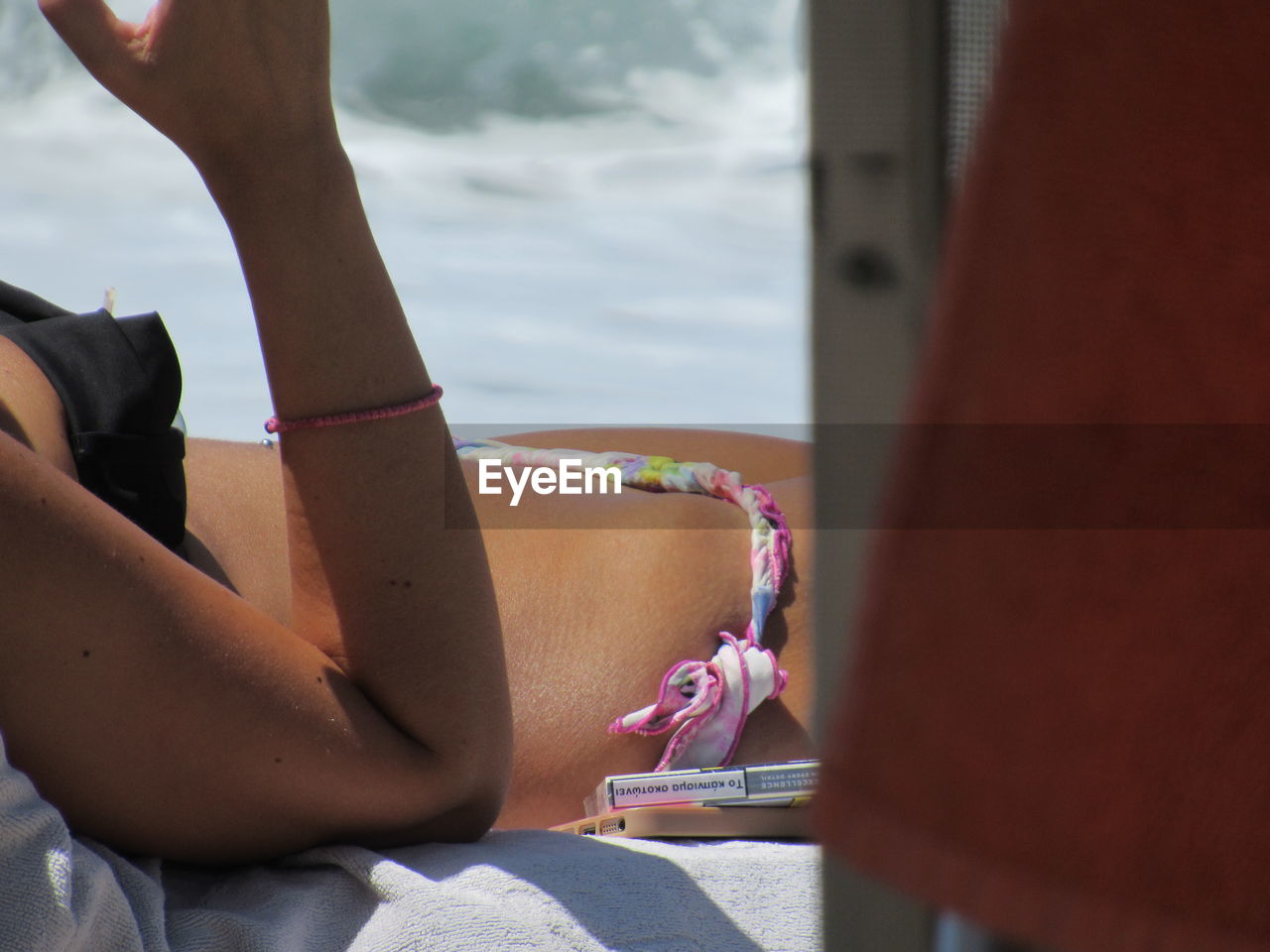 MIDSECTION OF WOMAN HAND WITH UMBRELLA AT BUS