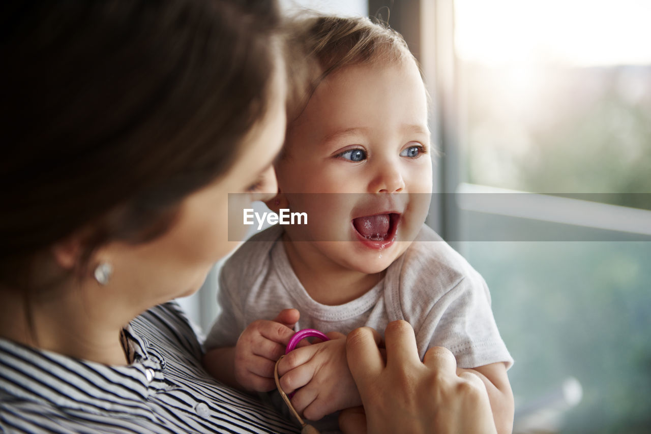 Close-up of mother and daughter at home