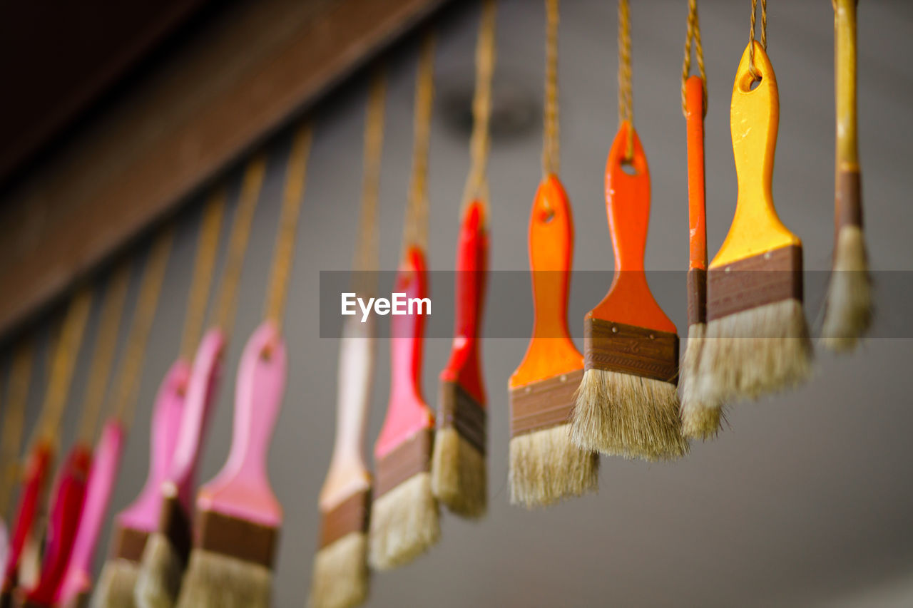 Close-up of clothespins hanging on wall