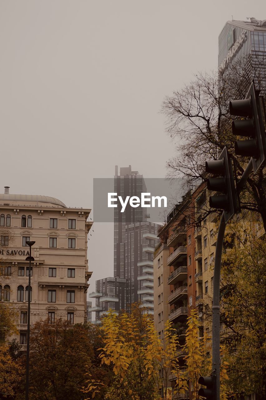 architecture, building exterior, built structure, urban area, building, cityscape, city, skyline, sky, tree, nature, evening, residential district, skyscraper, office building exterior, no people, plant, downtown, landmark, outdoors, travel destinations, clear sky, tower block, reflection, city life