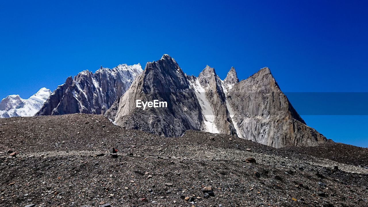 Scenic view of rocky mountains against clear blue sky