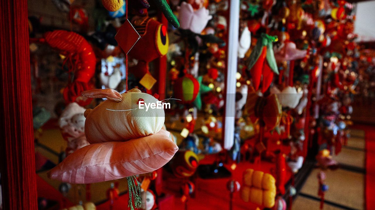 Close-up of decorations hanging at shop for sale