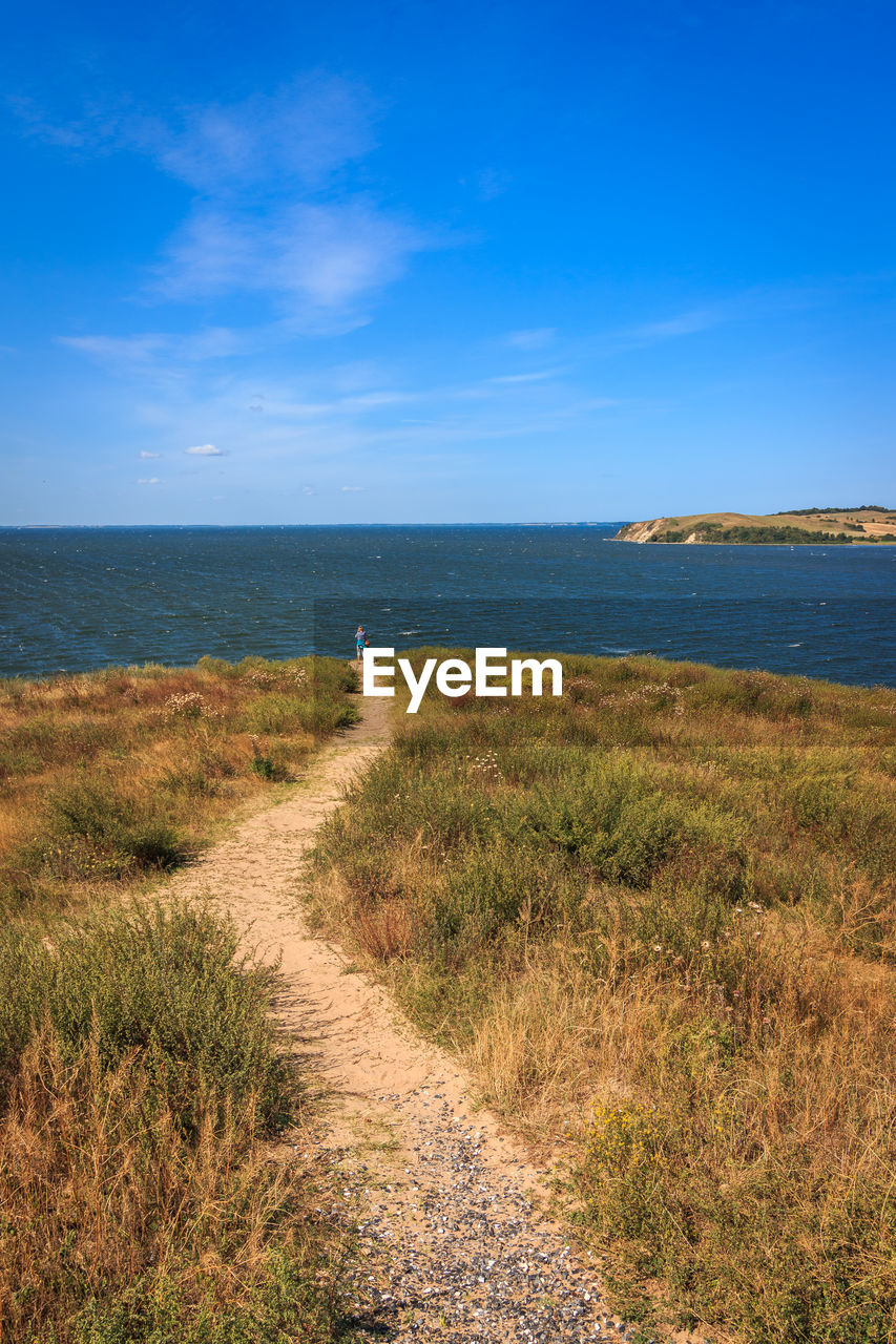 SCENIC VIEW OF SEA SHORE AGAINST SKY