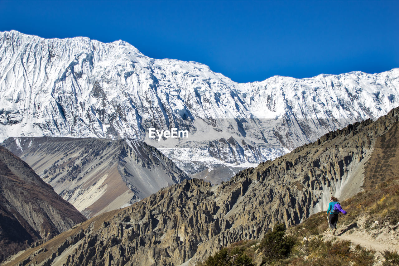 Scenic view of snowcapped mountains against clear sky