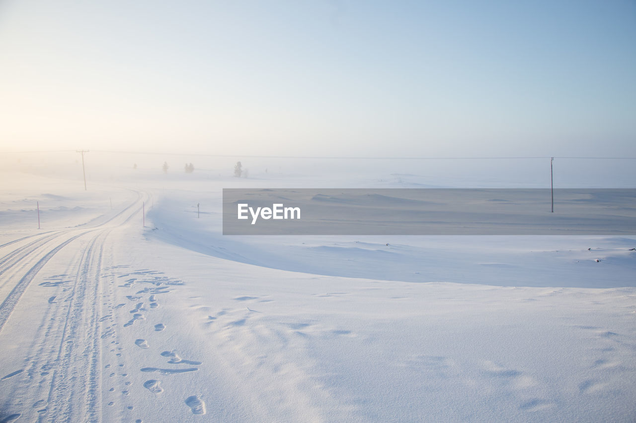 A beautiful, misty morning in the norwegian hills in winter. white, hazy landscape. 