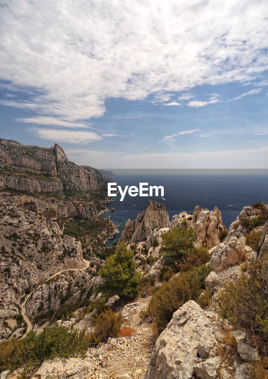 Rock formations by sea against sky