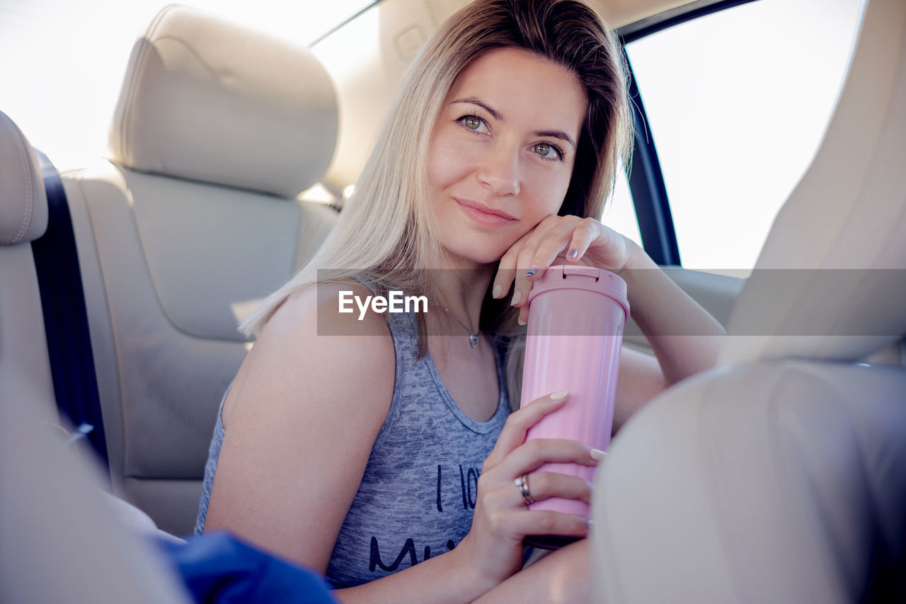 low angle view of young woman in car