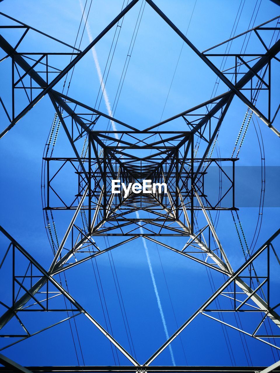 Low angle view of electricity pylon against sky