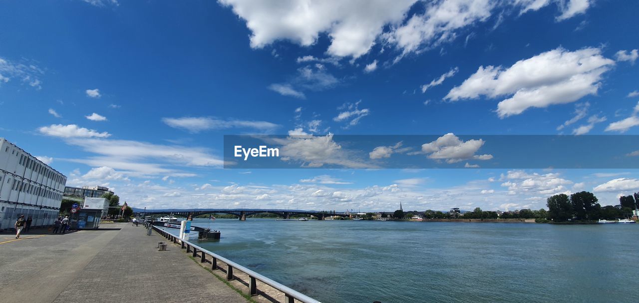 BRIDGE OVER RIVER AGAINST BLUE SKY