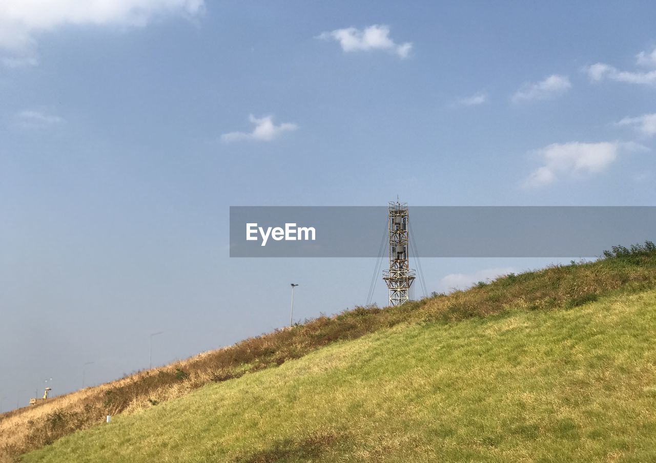 LOW ANGLE VIEW OF WINDMILL ON LAND