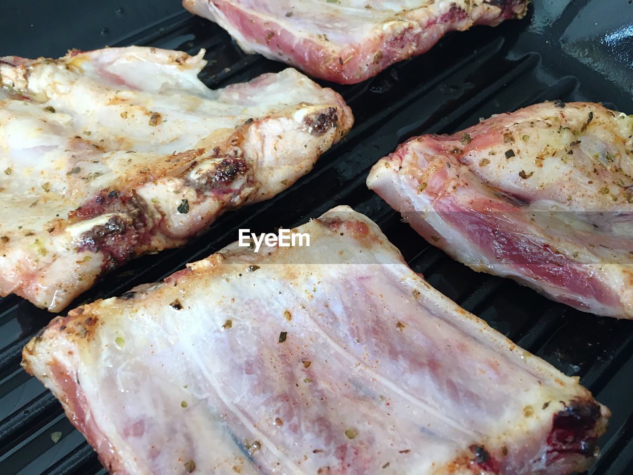 High angle view of ribs being roasted in griddle pan