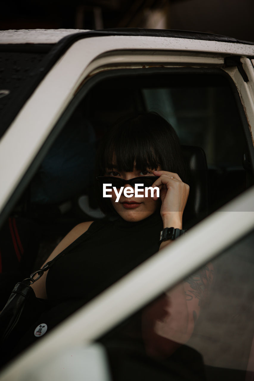 Portrait of woman sitting in car